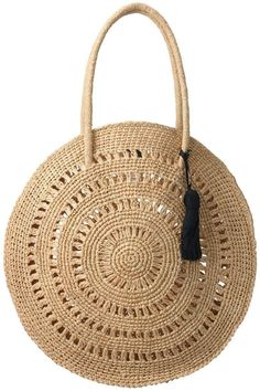 a round straw bag with a tasselled handle and an openwork design on the front