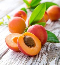 apricots with leaves on a wooden table