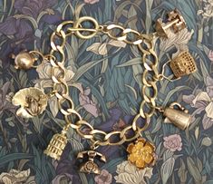 Beautiful thick (10x12mm) brass curb chain bracelet with 8  3D  brass charms. The charms are a mixture of new and vintage (unused) and include a handbag, rose, bird cage with hanging bird (new) and a frog on lilypad, coffee pot, telephone, kettle and carousel (vintage).  The bracelet is a lovely golden colour but as with all brass jewellery it will darken with time but can be repolished or left to form a natural patina as desired. The bracelet will be supplied in a velvet gift pouch. Luxury Antique Charm Bracelet, Affordable Vintage Gold Charm Bracelet, Cheap Vintage Charm Bracelet Gift, Luxury Retro Bracelet As Gift, Cheap Vintage Charm Brass Jewelry, Cheap Vintage Brass Jewelry With Charm, Affordable Vintage Charm Brass Jewelry, Cheap Vintage Charm Bracelet As Gift, Luxury Heirloom Bracelets With Vintage Charm