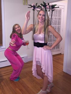 two women dressed in pink posing for the camera