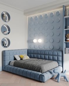 a bed sitting in the middle of a room next to a book shelf with books on it