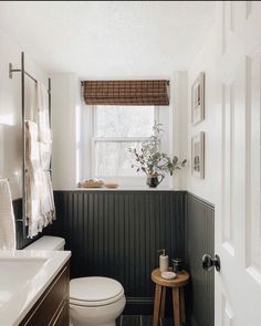 a white toilet sitting next to a window in a bathroom under a window sill