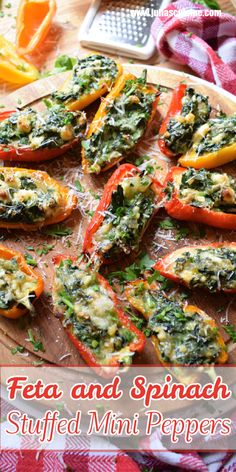 stuffed mini peppers with pesto and spinach in them on a wooden platter