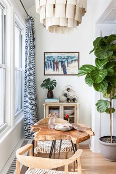 Transform your small dining area into a cozy retreat with this bohemian-inspired breakfast nook. Featuring a live-edge wood table, woven chairs, and a stunning fiddle-leaf fig, this space is full of natural textures and calming vibes. Add a statement chandelier and bold artwork for a unique, artistic touch! Natural Vibes, Small Dining Area, Bold Artwork, Historic Architecture