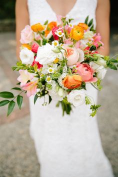 a bride holding a bouquet of flowers in her hand