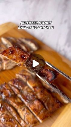 a wooden cutting board topped with sliced meat