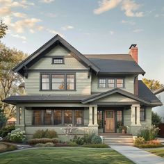 a large house with lots of windows on the front and side of it's roof