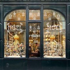 the front window of a store with many christmas decorations in it's glass windows