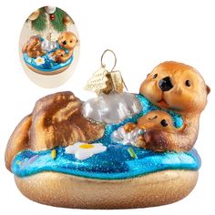 a glass ornament with a bear and baby bears in the water on it