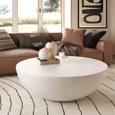 The Lensey Modern Concrete Round Coffee Table features a sleek, minimalistic design with a smooth, rounded form that exudes contemporary elegance. Its all-white or all-black concrete finish offers a striking aesthetic, making it a versatile centerpiece for any living space. The spacious, flat surface is perfect for displaying decor or accommodating drinks and snacks, while the bowl-like shape adds a unique touch to your interior. Orren Ellis Color: White Orren Ellis Lensey Concrete Round Coffee White Drum Coffee Table, Round Outdoor Coffee Table, Black Concrete, Drum Coffee Table, Stone Concrete, Concrete Finish, Outdoor Coffee Table, Coffee Table White, Outdoor Coffee Tables