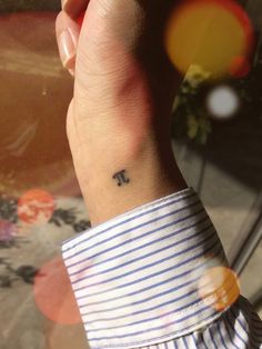 a person with a small tattoo on their wrist