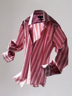 a red and white striped shirt hanging on a clothes line