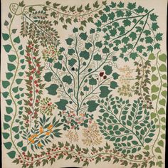 an embroidered wall hanging with leaves and berries