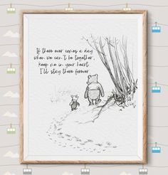 a winnie the pooh quote is hanging on a wall next to a framed photo