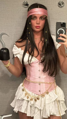 a woman in a pink corset holding an ipod