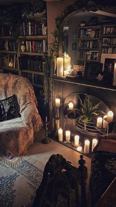 a living room filled with lots of candles next to a fire place and bookshelf