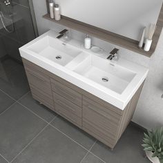 two white sinks sitting under a mirror in a bathroom