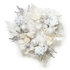 a white and silver christmas wreath with snowflakes, ornaments and leaves on it