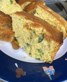 two pieces of cornbread on a blue and white plate