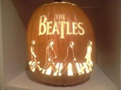 an illuminated pumpkin with the beatles on it