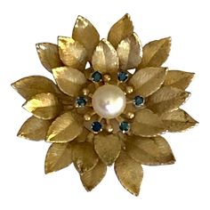 This is part of Chairish’s Costume Jewelry assortment.  This lovely 1950s Krementz Sapphire Crystal and Cultured Pearl Floral Brooch Pin will look amazing on your lapel or scarf, year round. All stones are intact as well as the gold leaf finish. A beautiful, traditional and classic piece for the vintage jewelry collector!  Dimensions: 1.4”W  x 1.4”L Marks: “Krementz” on the pin as pictures Condition: excellent vintage condition Mid-century Yellow Gold Brooch For Gifts, Mid-century Yellow Gold Brooch Jewelry, Mid-century Yellow Gold Brooch, Heirloom Gold Brooches For Evening, Heirloom Gold Evening Brooches, Mid-century Gold Brooches For Vintage Events, Gold Costume Jewelry Brooches For Vintage Events, Mid-century Gold Brooch Jewelry, Vintage Yellow Gold Brooch For Anniversary