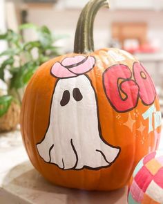 a painted pumpkin with a ghost on it