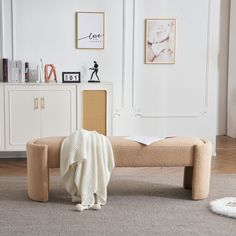 a living room with a couch, rugs and pictures on the wall behind it