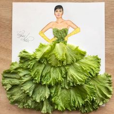 a woman in a green dress made out of lettuce on top of a piece of paper