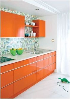 a kitchen with orange cabinets and green bowls