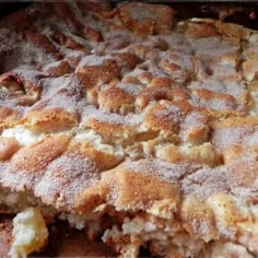 a close up of food on a pan with some powdered sugar and other toppings