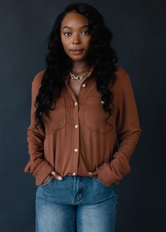 The perfect button up for the season ahead! This super soft button up shirt will be a versatile addition to your wardrobe to dress up or down. Brown super soft button up top Long sleeves Two front pockets at the bust Button closure on the front Designed in the U.S.A. Produced in China.  Model is wearing a size small 75% Rayon / 15% Acrylic / 10% Spandex SIZE CHART S: Bust: 40" / Length: 24.5" M: Bust: 42" / Length: 25.5" L: Bust: 44" / Length: 26.5" XL: Bust: 46" / Length: 27.5" Dark Fall Outfits, L Dk, Blouse Tank Top, Denim Sweater, Closet Goals, Button Up Top, Long Jumpsuits, Sweaters Crewneck, Vintage Sweatshirt