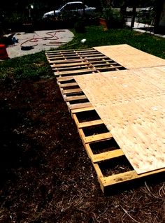 an unfinished wooden floor in the middle of a yard