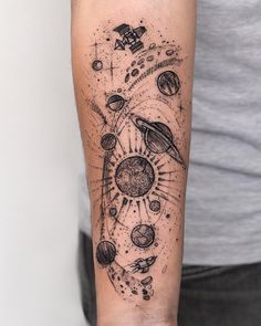 a man's arm with an image of planets and stars on the inside of it