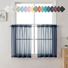 a window with blue sheer curtains in front of it and an assortment of colors on the windowsill