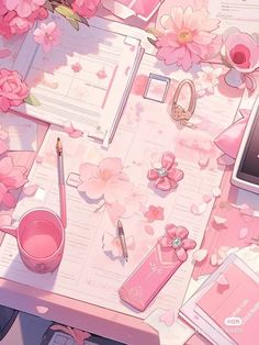 a pink desk topped with lots of papers and flowers next to a cell phone on top of a table