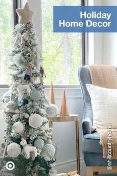 a white christmas tree in a living room next to a chair and window with presents on it