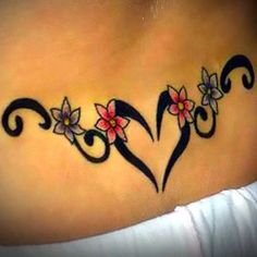 a woman's stomach with two hearts and flowers tattoo on the back of her chest