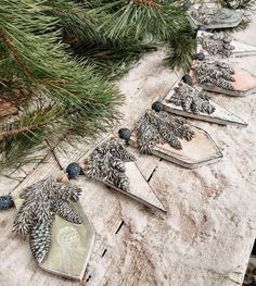 some ornaments are sitting on a table next to a pine tree