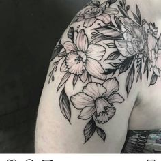 a woman's shoulder with flowers on it