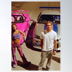 a man standing next to a woman in front of a pink car