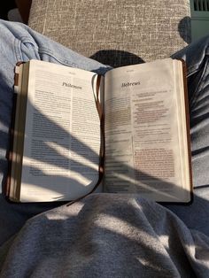 an open book sitting on top of a person's lap