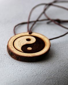 Oriental Yin Yang, Yin yang pendant necklace, Pendant Necklaces, Symbol Necklaces, Yin Yang, Zen, yoga, Meditation Gift, spiritual jewelry This wood pendant is cut from raw tree, it has delightful and nice smell. You can feel it as you are in the forest. This Ying yang engraved symbol wood pendant necklace is  designed by me Katie. The leather necklace is adjustable. it is handmade item. That is the new idea to bring this to the interested people. Hope i can help you get it into what you want and what you thought about. Ying Yang Jewelry, Zen Yoga, Symbol Necklace, Personalized Anniversary Gifts, Meditation Gifts, Ying Yang, Personalized Anniversary, Wood Pendant, Spiritual Jewelry