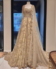 a wedding dress on display in front of a window