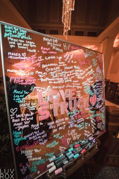 a large blackboard with writing on it in a restaurant or bar that says love struck