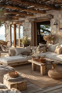 an outdoor living area with couches and tables