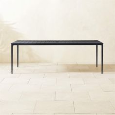 a black table sitting on top of a tiled floor