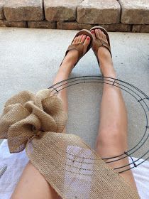 a woman's feet in flip flops sitting on a towel