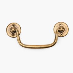 an antique brass door handle on a white background