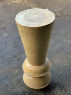 a small wooden object sitting on the ground