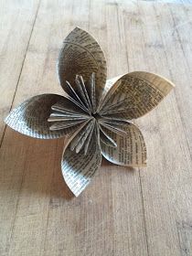 a paper flower sitting on top of a wooden table